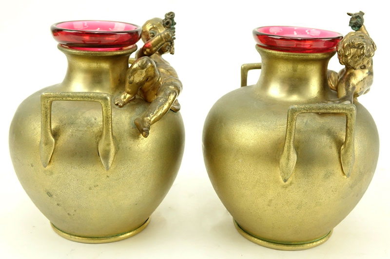 In the Manner of: Aguste Moreau, French (1834-1917) Pair of Art Nouveau Bronze Handle Vases with Cranberry Glass Insert