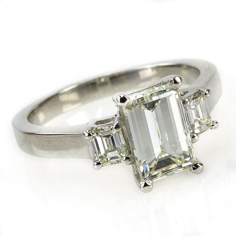 1.92 Carat TW Diamond and Platinum Engagement Ring. Set in the center with an approx. 1.55 carat emerald cut diamond and accented with two .37 carat TW emerald cut diamonds.