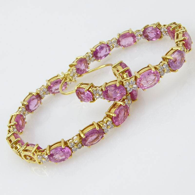 19.97 Carat Oval Cut Pink Sapphire. 1.70 Carat Round Brilliant Cut Diamond and 18 Karat Yellow Gold Hoop Earrings.