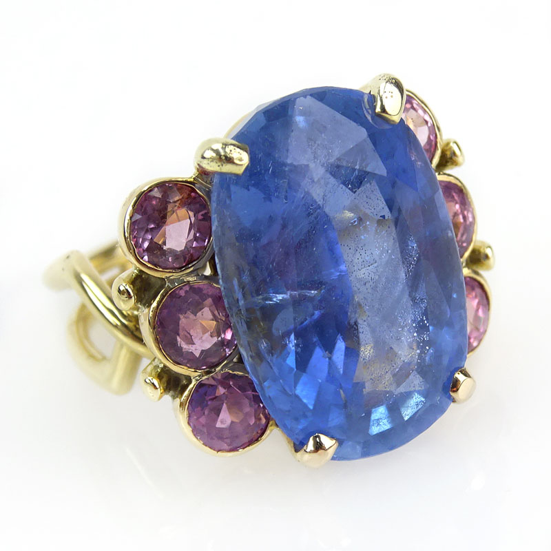 30.0 Carat Oval Cut Natural Unheated Sapphire, 1.50 Carat Round Cut Pink Sapphire and 18 Karat Yellow Gold Ring. 