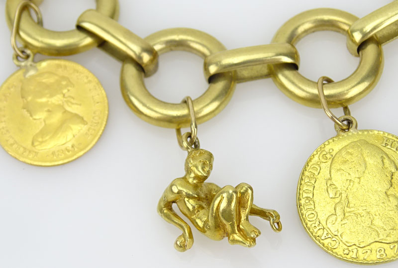 Vintage 18 Karat Yellow Gold Charm Bracelet with Seven Gold Coins Including Cuban, Mexican, Peruvian and Spanish Coins and a Reclining Man Charm