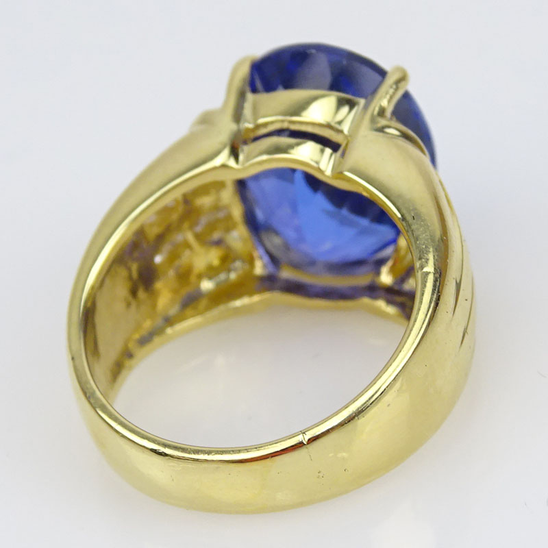 12.30 Carat Oval Cut Tanzanite, Princess Cut Diamond and 18 Karat Yellow Gold Ring.