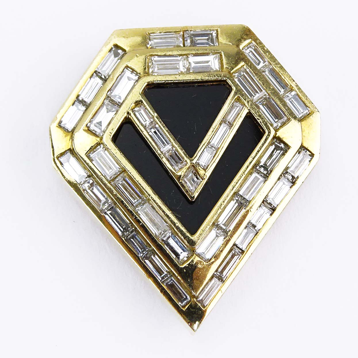 Vintage Piaget Approx. 3.25 Carat Baguette Cut Diamond, Black Onyx and 18 karat Yellow Gold Clip Brooch.