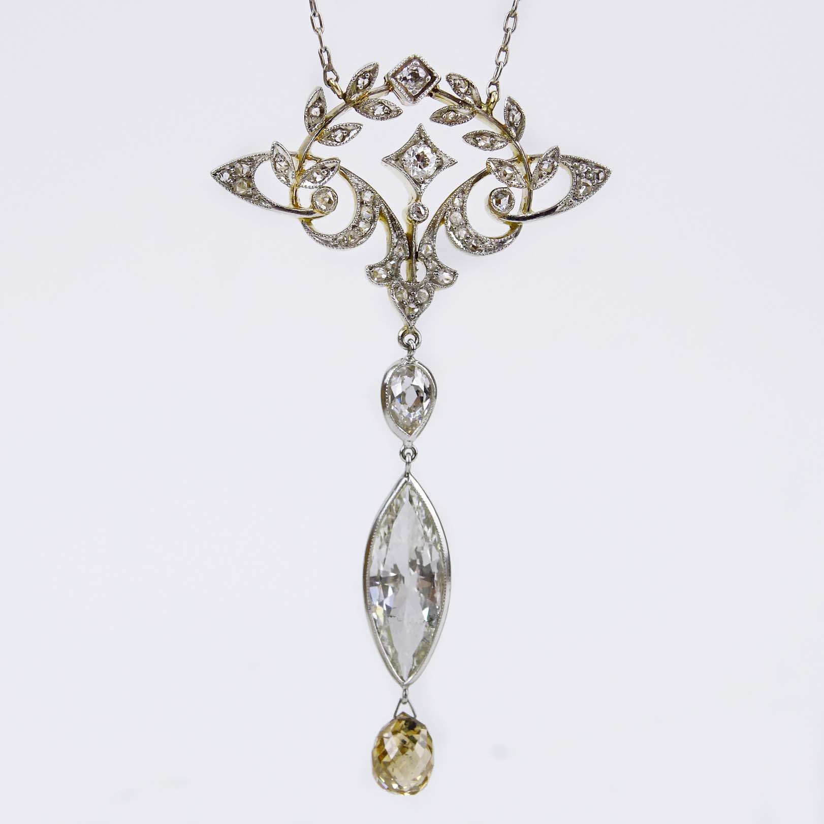 Antique Platinum and 18 Karat Yellow Gold Pendant Necklace Set with an Approx. 2.40 Carat Marquise Cut Diamond, 1.50 Carat Fancy Yellowish Brown Briolette Cut Diamond and further accented with 2.25 Carat Diamonds. 