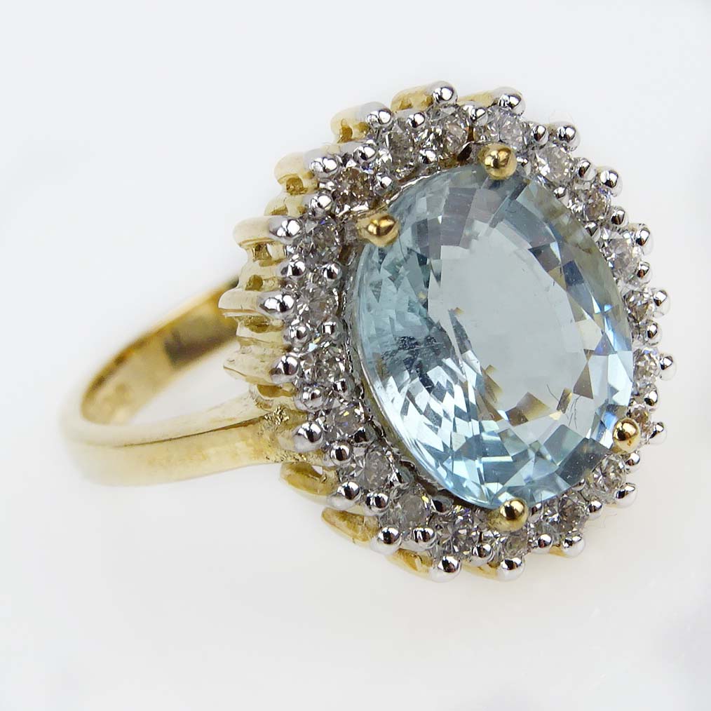 Contemporary 3.32 Carat Oval Cut Aquamarine, Diamond and 9 Karat Yellow Gold Ring. 