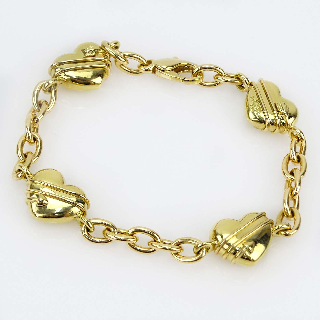 Tiffany & Co 18 Karat Yellow Gold Four Hearts Charm Bracelet.