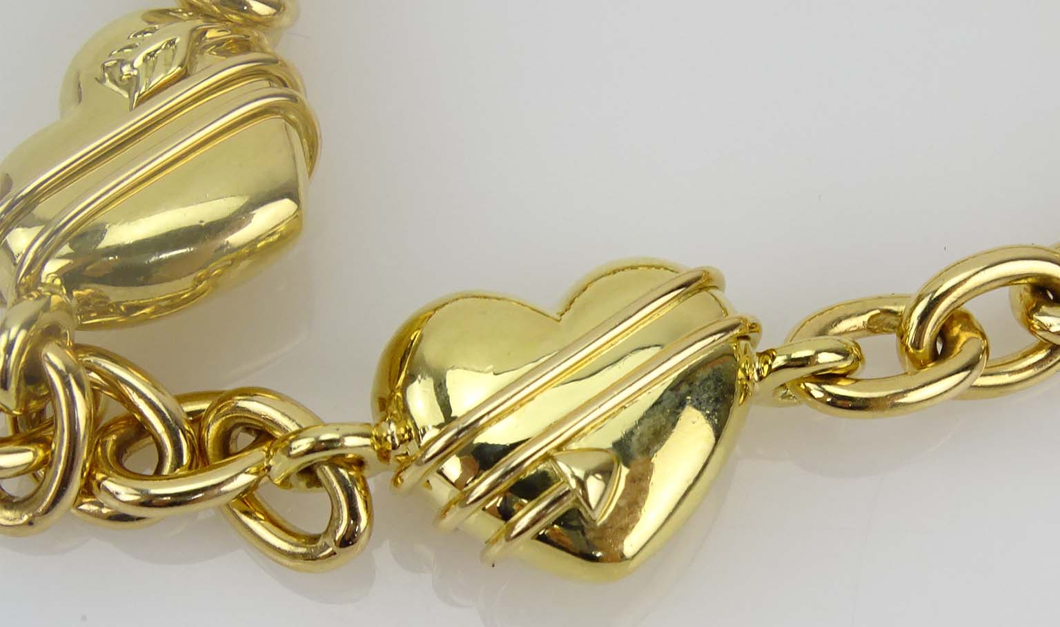 Tiffany & Co 18 Karat Yellow Gold Four Hearts Charm Bracelet.