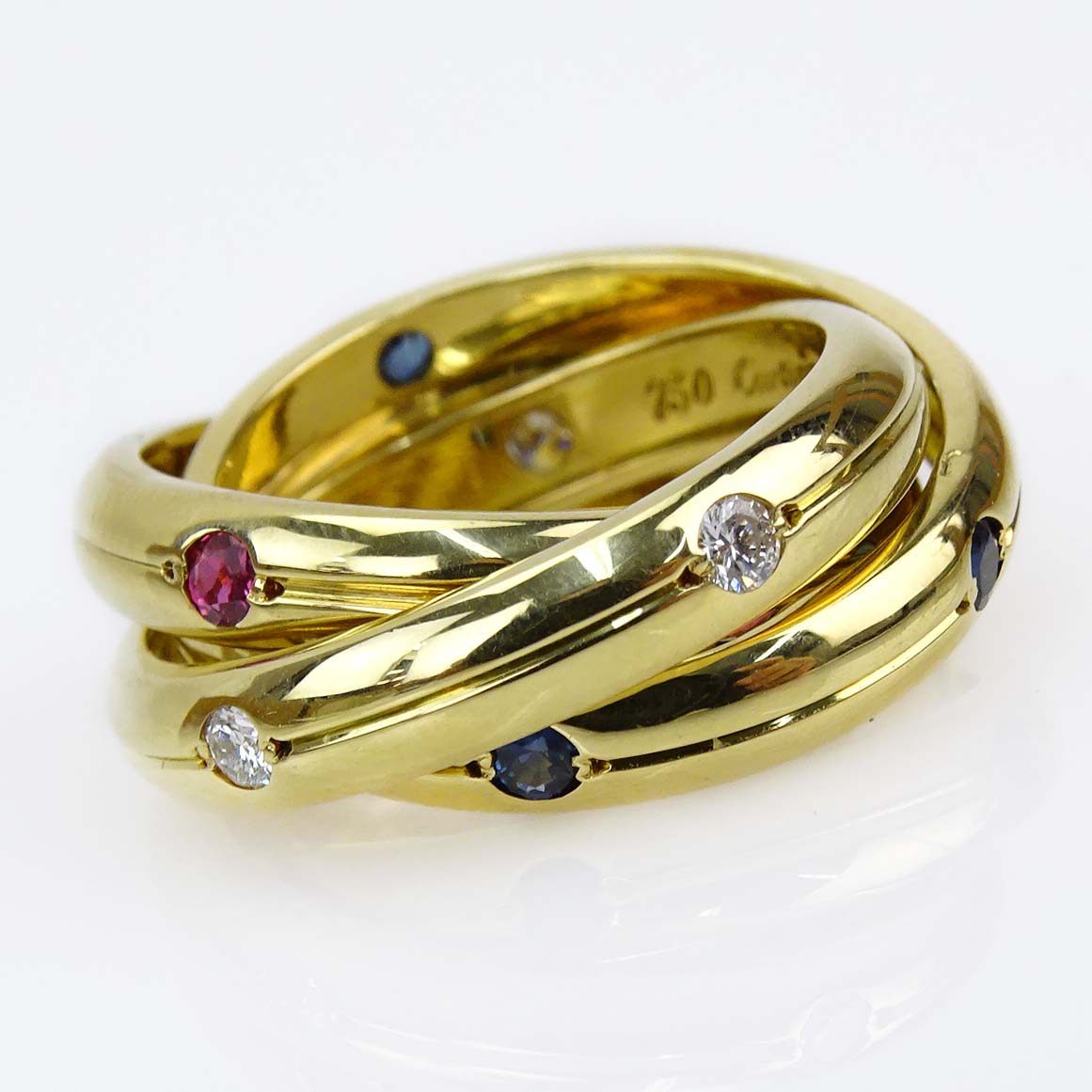 Cartier 18 Karat Yellow Gold Approx. .20 Carat Diamond, .25 Carat Sapphire and .25 Carat Ruby Trinity Ring.