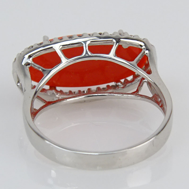 Oval Cabochon Red Coral, .40 Carat Diamond and 18 Karat White Gold Ring. 