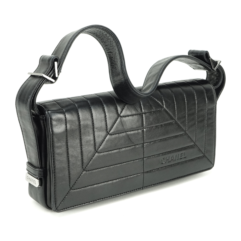 Chanel Black Lambskin Flap Bag. Silver tone hardware, "Chanel" fabric interior with zipper pocket. 