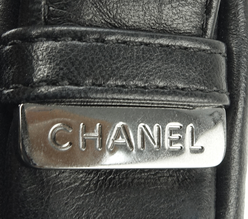 Chanel Black Lambskin Flap Bag. Silver tone hardware, "Chanel" fabric interior with zipper pocket. 