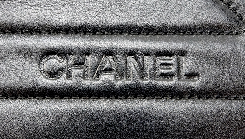 Chanel Black Lambskin Flap Bag. Silver tone hardware, "Chanel" fabric interior with zipper pocket. 