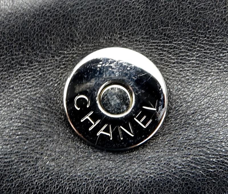 Chanel Black Lambskin Flap Bag. Silver tone hardware, "Chanel" fabric interior with zipper pocket. 