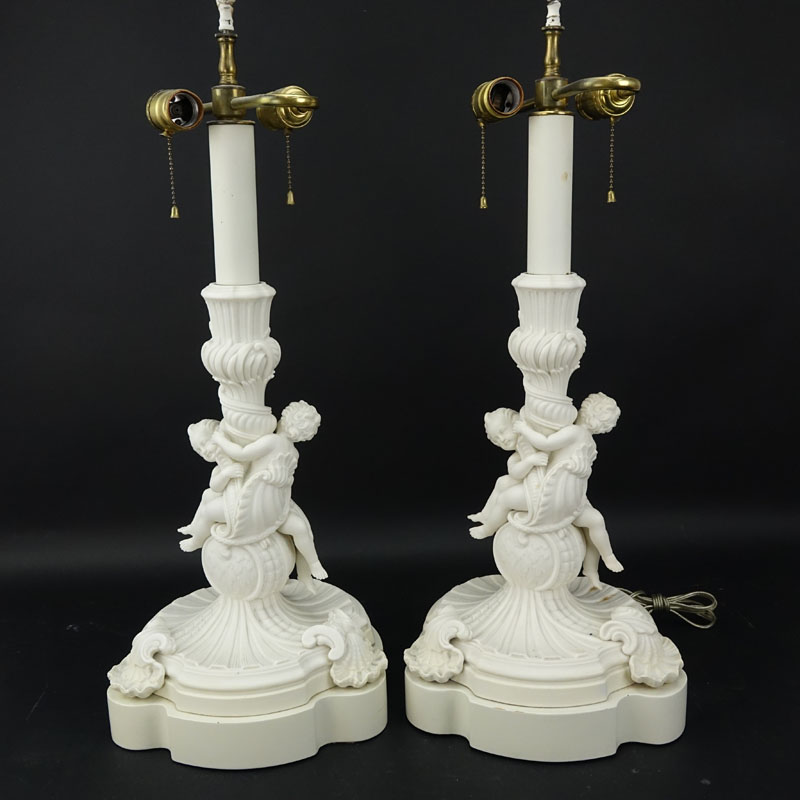 Pair of 19/20th Century Sevres Style Bisque Cherub Figural Lamps with Cherub Finials.