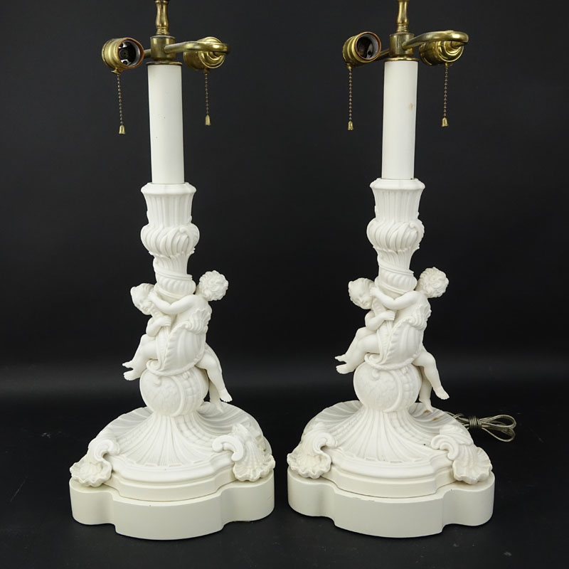 Pair of 19/20th Century Sevres Style Bisque Cherub Figural Lamps with Cherub Finials.