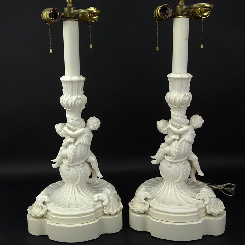 Pair of 19/20th Century Sevres Style Bisque Cherub Figural Lamps with Cherub Finials.