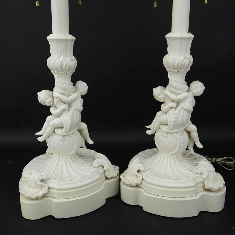 Pair of 19/20th Century Sevres Style Bisque Cherub Figural Lamps with Cherub Finials.