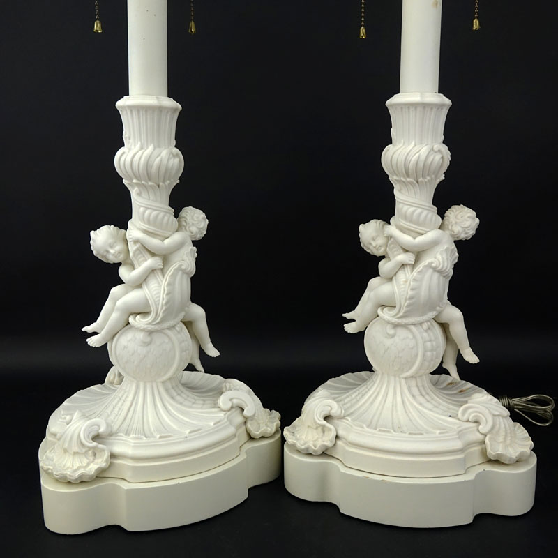 Pair of 19/20th Century Sevres Style Bisque Cherub Figural Lamps with Cherub Finials.