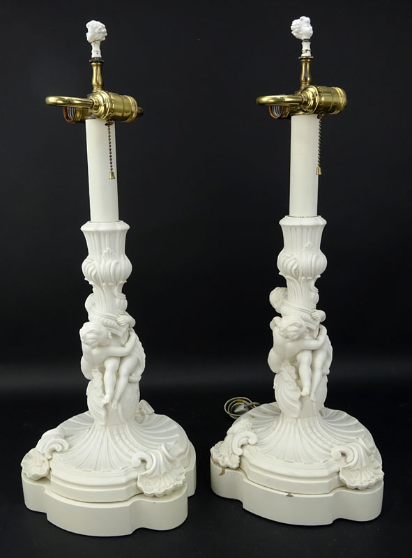 Pair of 19/20th Century Sevres Style Bisque Cherub Figural Lamps with Cherub Finials.