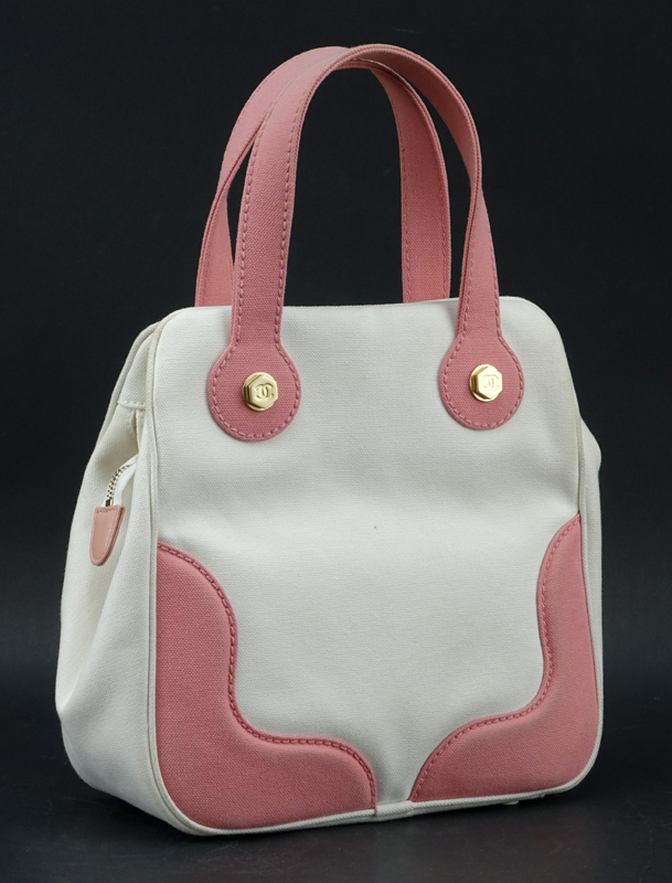 Chanel Pink & White Canvas Tote. Matte gold hardware, "Chanel" fabric interior with zipper pocket. Labeled appropriately. 