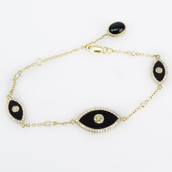 Approx. .85 Carat Diamond, Black Onyx and 14 Karat Yellow Gold Bracelet. 