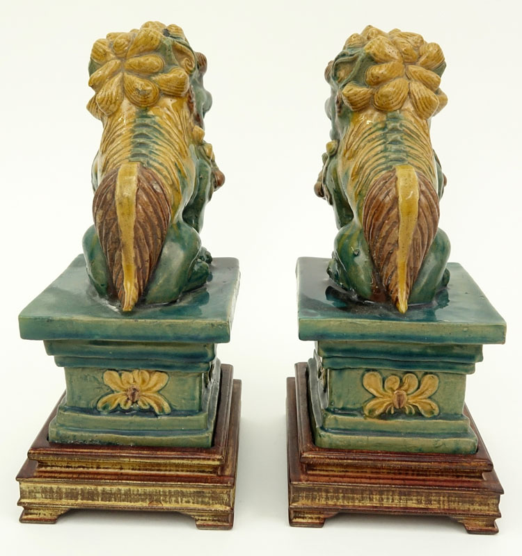 Pair Chinese Sancai Glaze Pottery Foo Dog Figures on Wood Bases.