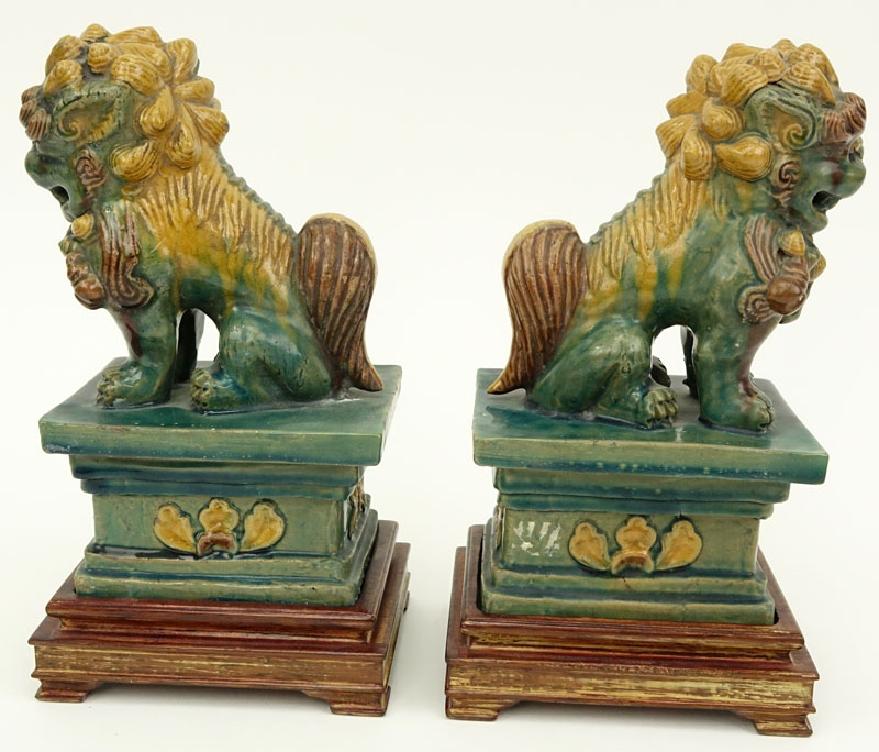 Pair Chinese Sancai Glaze Pottery Foo Dog Figures on Wood Bases.