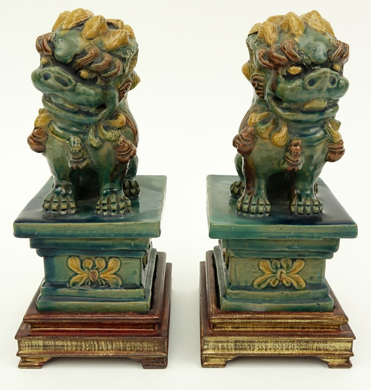 Pair Chinese Sancai Glaze Pottery Foo Dog Figures on Wood Bases.