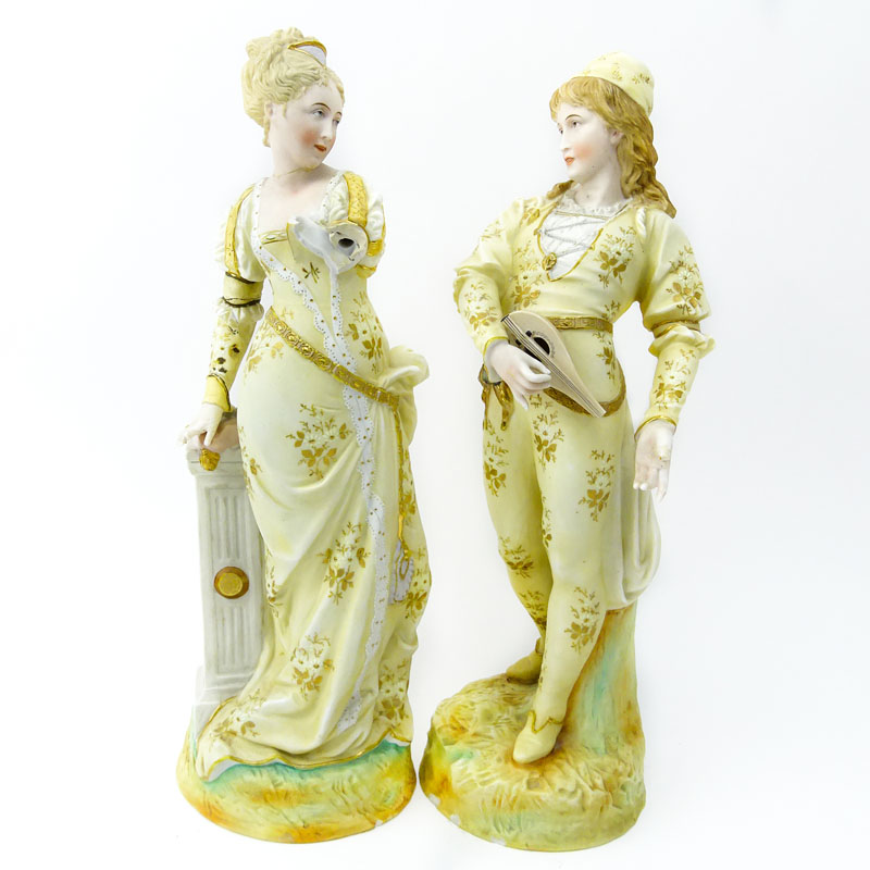 Two (2) Porcelain Figurines. Man & Woman in costume.