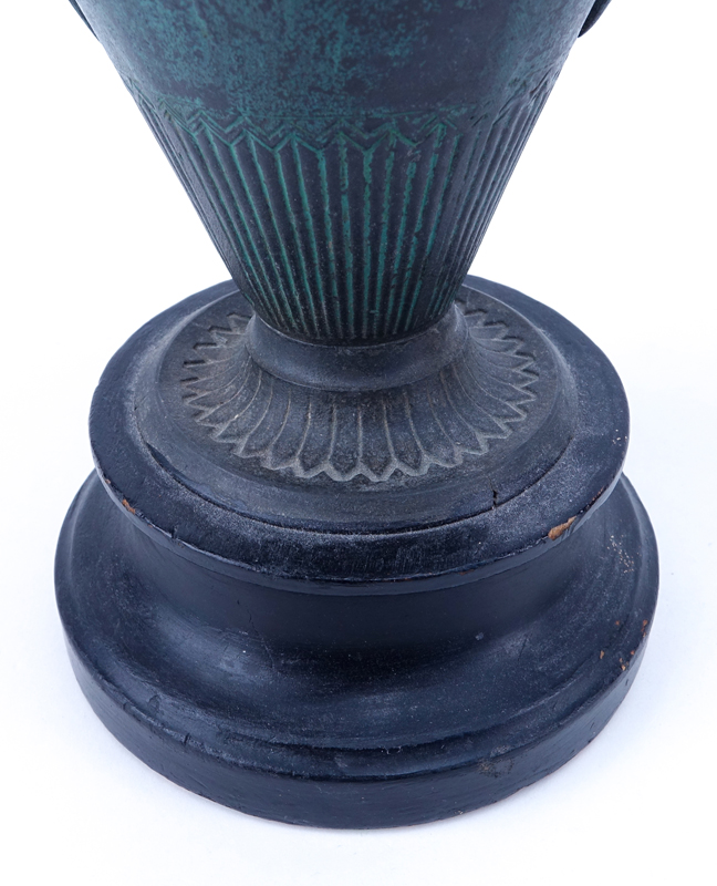 Pair of Late 19th Century Continental Neoclassical style White Metal Urns on Stepped Wood Bases.