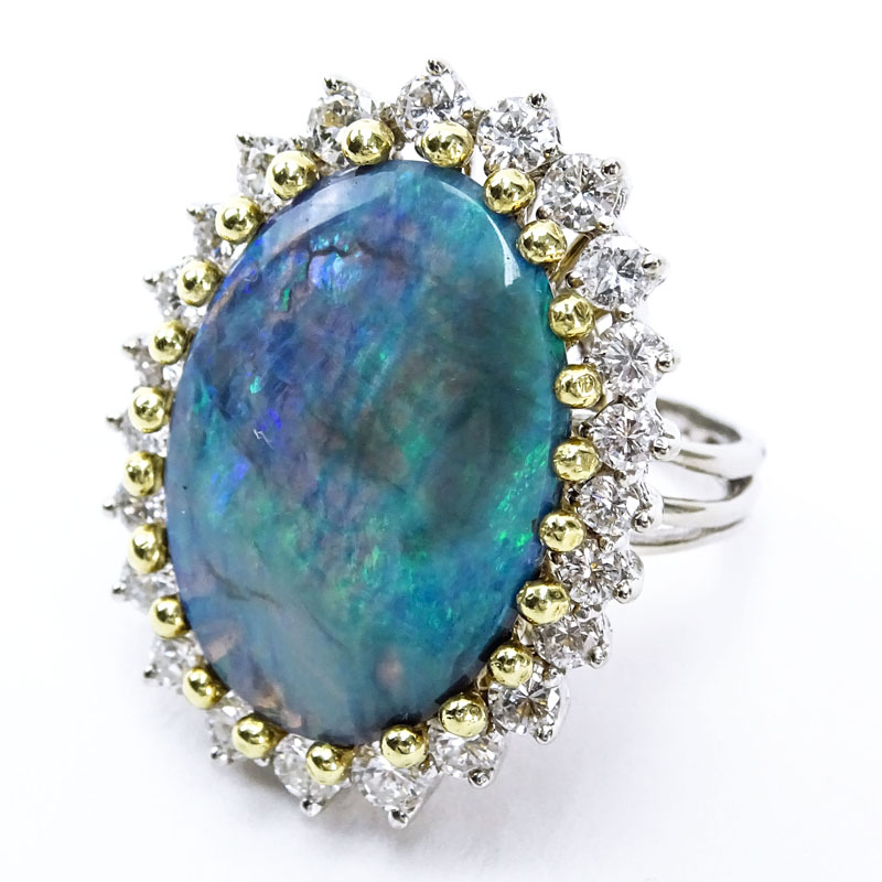 Vintage Approx. 9.0 Carat Oval Cut Opal, 2.0 Carat Round Brilliant Cut Diamond and 18 Karat White and Yellow Gold Ring. Diamonds E-F color, VVS-VS clarity. 