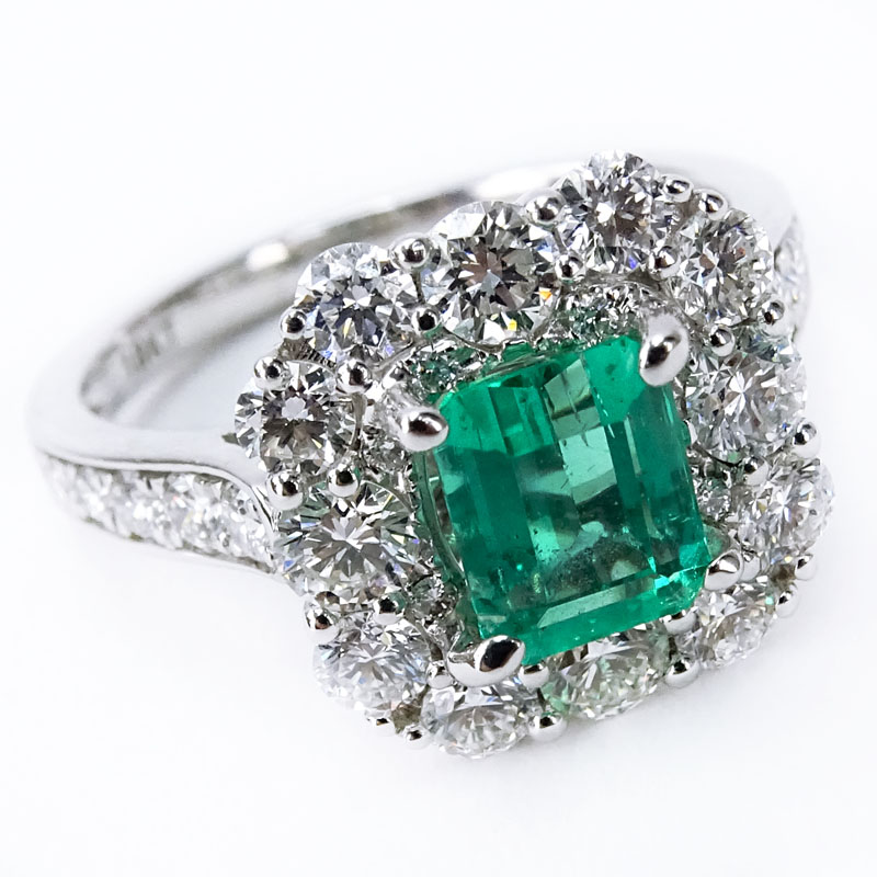 Approx. 1.55 Carat Round Brilliant Cut Diamond, Square Cut Emerald and 18 karat White Gold Halo Ring. 