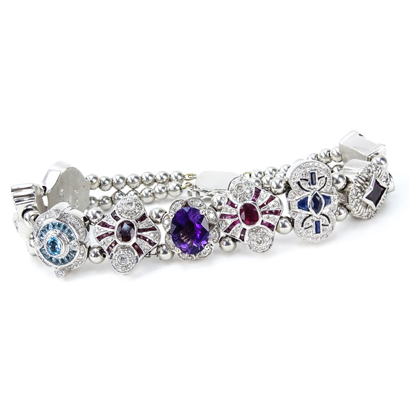 Vintage R. Klein 14 Karat White Gold and Diamond, Ruby, Sapphire, Amethyst and Blue Topaz Charm Bracelet. 