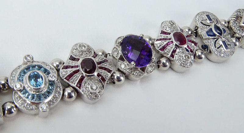 Vintage R. Klein 14 Karat White Gold and Diamond, Ruby, Sapphire, Amethyst and Blue Topaz Charm Bracelet. 