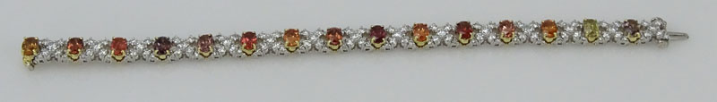 Approx. 11.25 Carat Oval Cut Multi Color Sapphire, 6.0 Carat Round Brilliant Cut Diamond and Platinum and 18 Karat Yellow Gold XO Bracelet. 