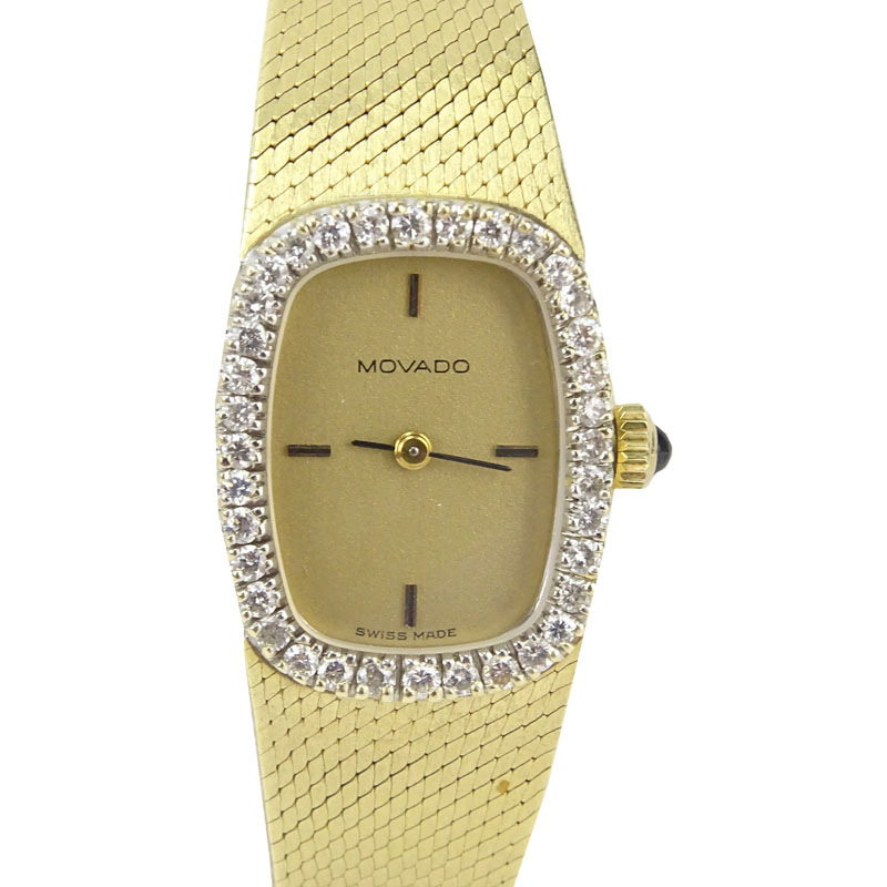 Lady's Vintage Movado 14 Karat Yellow Gold Bracelet watch with Diamond Bezel and with Swiss 17 Jewel Zenith Manual Movement.