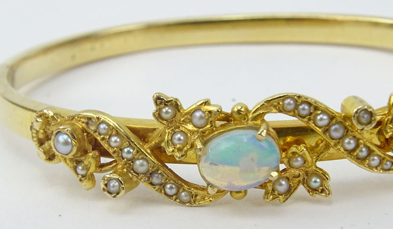 Vintage 14 Karat Yellow Gold Bangle Bracelet set with an Oval Cut Opal and Seed pearls.