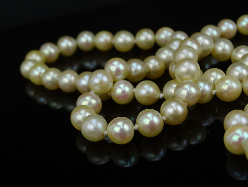 Vintage Single Strand White Pearl Necklace with 14 Karat Yellow Gold Clasp accented with Diamonds and Rubies.