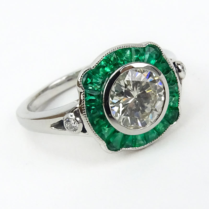 Approx. 1.10 Carat Round Brilliant Cut Diamond, .63 Carat Calibre Cut Emerald and Platinum Ring. .