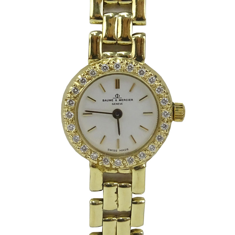 Lady's Vintage Baume & Mercier Genève 14 Karat Yellow Gold Bracelet Watch with Diamond Bezel.