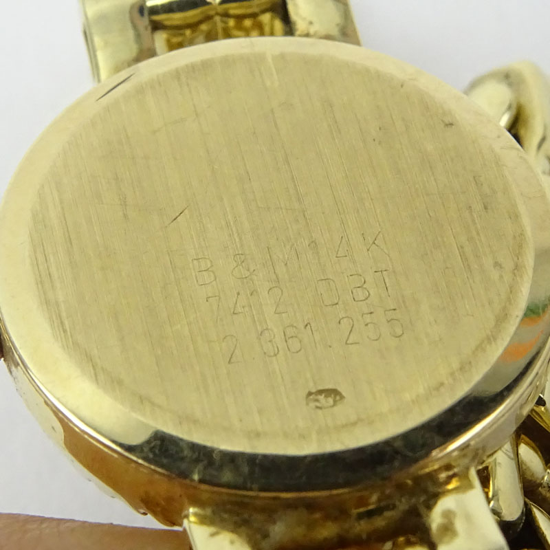 Lady's Vintage Baume & Mercier Genève 14 Karat Yellow Gold Bracelet Watch with Diamond Bezel.