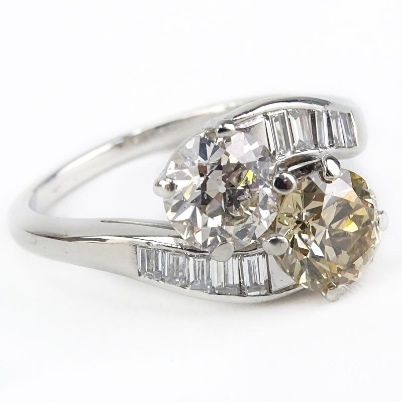 Art Deco Approx. Diamond and Platinum Bypass Ring set with an Approx. 1/32 Carat Round Brilliant Cut Fancy Brownish Yellow Diamond and 1.15 Round Brilliant Cut Diamond I Color, SI1 clarity and Further Accented with .50 Carat Baguette Diamonds. 