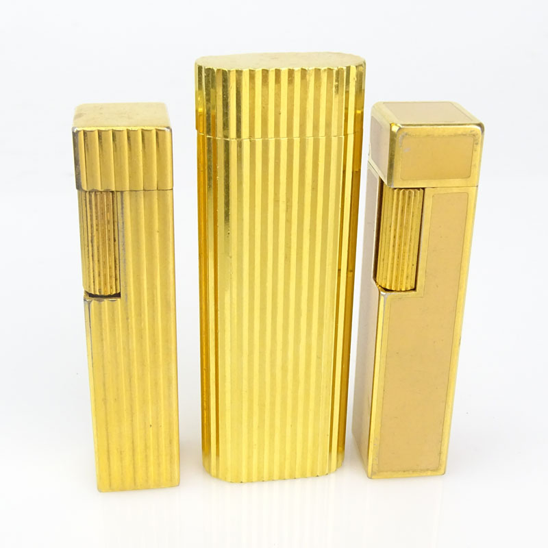 Three (3) Vintage Cartier Gold Plate Butane Cigarette Lighters, One with Lacquer. 