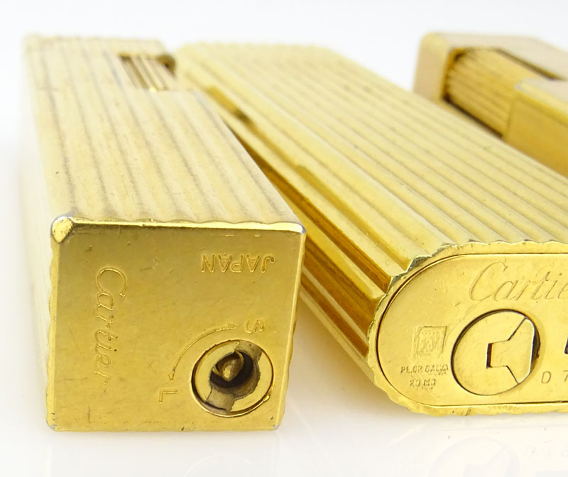 Three (3) Vintage Cartier Gold Plate Butane Cigarette Lighters, One with Lacquer. 