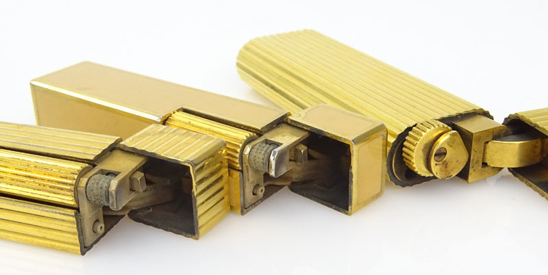 Three (3) Vintage Cartier Gold Plate Butane Cigarette Lighters, One with Lacquer. 