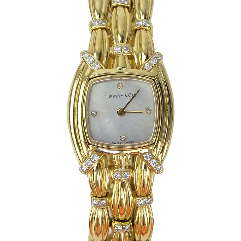 Tiffany & Co 18 Karat Yellow Gold and Diamond Signature Bracelet Watch, Mother of Pearl Dial, Swiss Automatic Movement. 