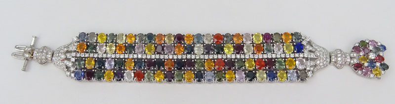 Approx. 75.48 Carat Oval Cut Multi Color Sapphire, 4.85 Carat Round Brilliant Cut Diamond and 18 Karat White Gold Wide Bracelet. 