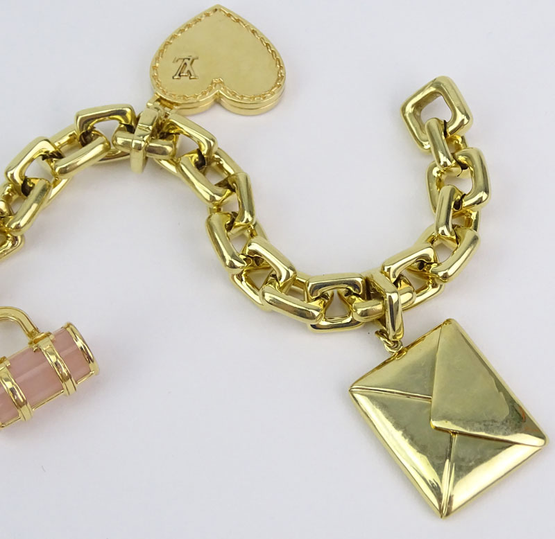 Louis Vuitton Heavy 18 Karat Yellow Gold and Pink Quartz Charm Bracelet with Four Charms.