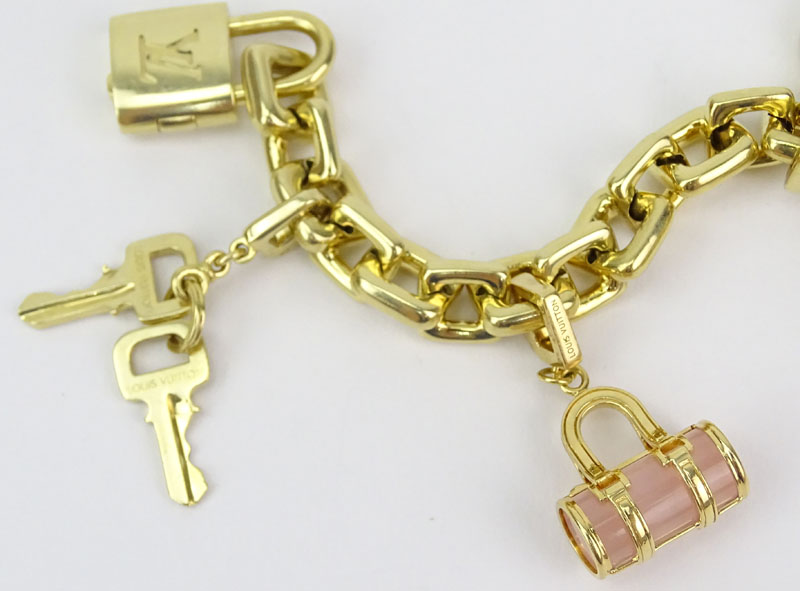 Louis Vuitton Heavy 18 Karat Yellow Gold and Pink Quartz Charm Bracelet with Four Charms.