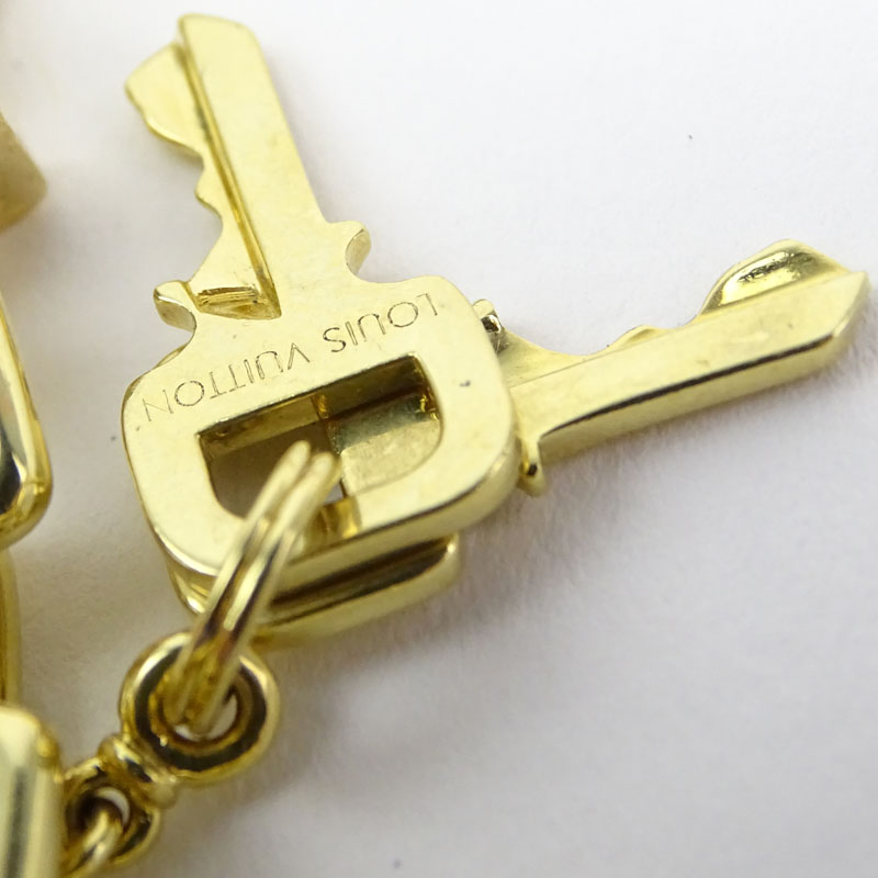 Louis Vuitton Heavy 18 Karat Yellow Gold and Pink Quartz Charm Bracelet with Four Charms.